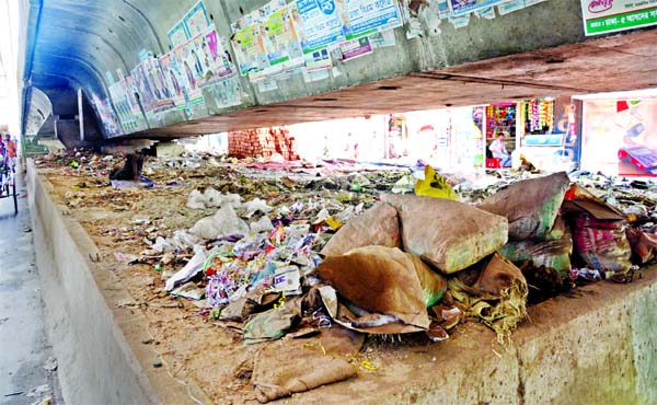 Several garbage being dumped underneath the Hanif Flyover by the roadside stores and houses as no steps being taken by the authorities concerned to remove those immediately. The photo taken on Wednesday shows that garbage scattered below the flyover's me