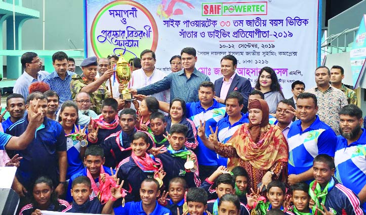 The winners of the Saif Powertec 33rd National Age Group Swimming & Diving Competition with the chief guest State Minister for Youth and Sports Zahid Ahsan Russell, MP, and the officials of Bangladesh Swimming Federation pose for a photo session at the Sy