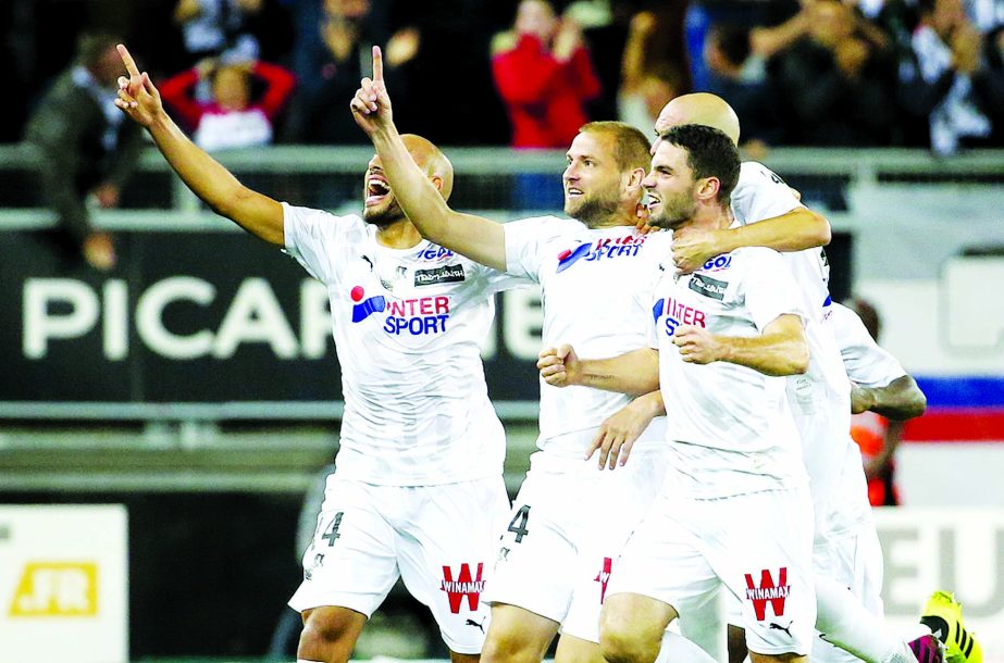 Players of Amiens celebrate scoring a late equalizer to draw the match 2-2 against Lyon, in Amiens, France on Friday.