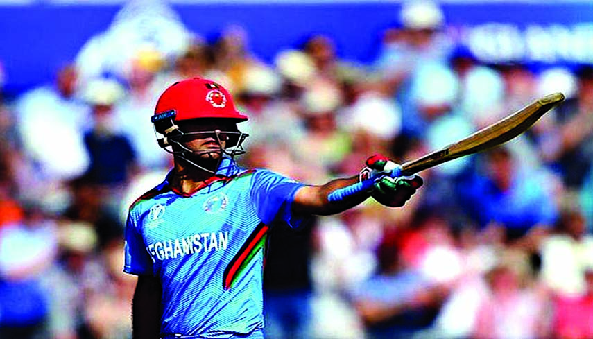 Najibullah Zadran of Afghanistan, celebrates his half-century during the second Twenty20 International match of the OBHAI Tri-nation T20 series between Afghanistan and Zimbabwe at the Sher-e-Bangla National Cricket Stadium in the city's Mirpur on Saturda