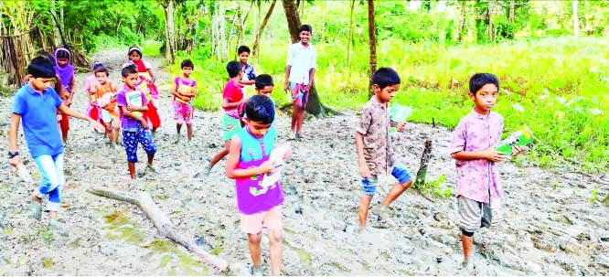 BETAGI (Barguna): School going-children facing difficulties as Jatisabazar Russel Square to Hosanabad Government Primary School road has badly damaged due to rainfall. This snap was taekn yesterday.