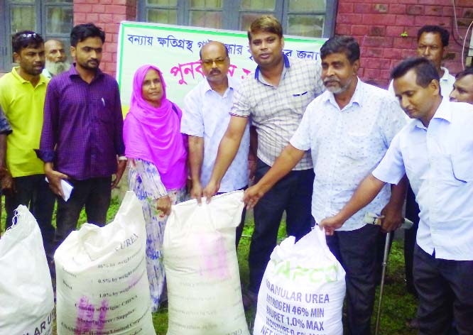 SAGHATA (Gaibandha): AK M Moniruzzaman, Upazila Agriculture Officer inaugurating fertiliser distribution programme among the flood- hit farmers at Saghata Upazila recently.