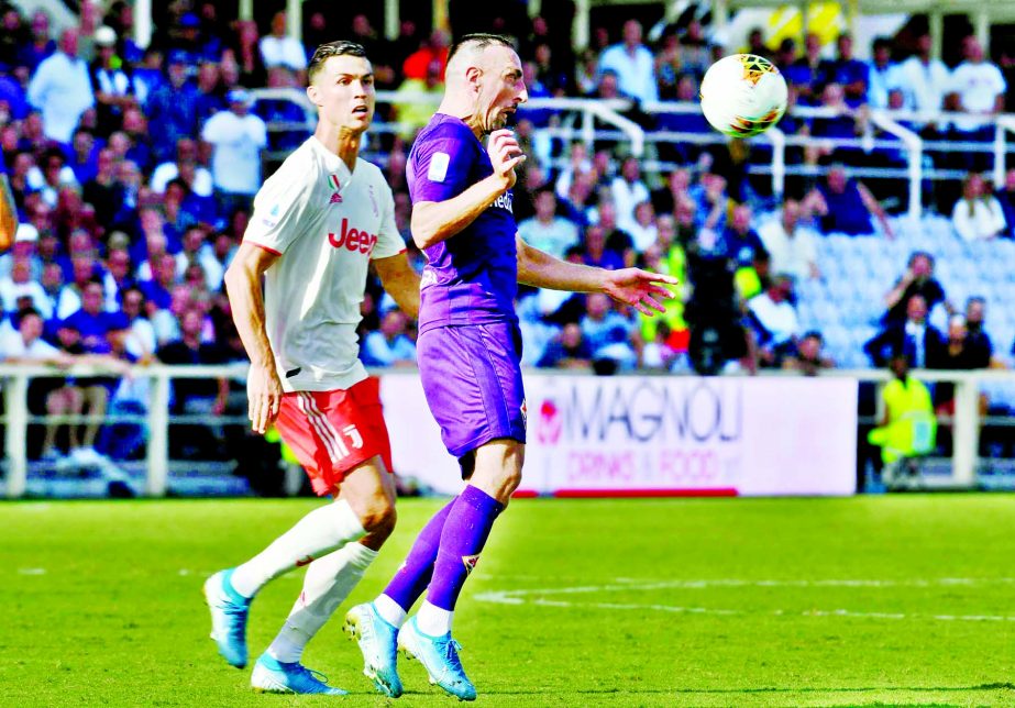 Fiorentina's Franck Ribery (right) and Juventus' Cristiano Ronaldo go for the ball during the Serie A soccer match between Fiorentina and Juventus, at the Artemio Franchi stadium in Florence, Italy on Saturday.