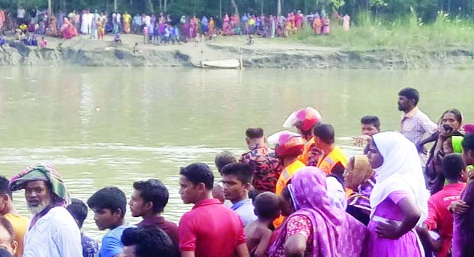 MIRZAPUR (Tangail): People gathered on the bank of river as Fire Service men trying to recover missing body of a college student yesterday.