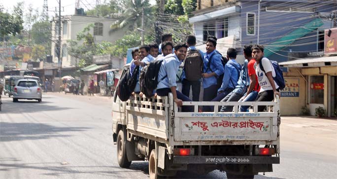School students going back to home in truck due to crisis of transport in the Port City . This picture was taken from Zakir Hossain Road yesterday.