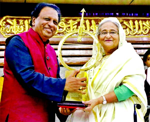 Prime Minister Sheikh Hasina receiving Dr Kalam Smiriti International Excellence Awards-2019 of India from its Chief Advisor T. P. Sreenivasan at a function held at the Prime Minister's office in the capital on Monday.