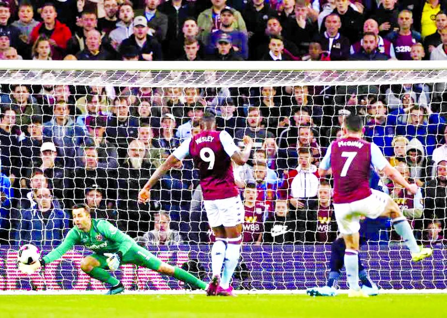 West Ham's goalkeeper Lukasz Fabianski (left) makes a save in front of Aston Villa's John McGinn (right) during their English Premier League soccer match between Aston Villa and West Ham United at Villa Park in Birmingham, England on Monday.