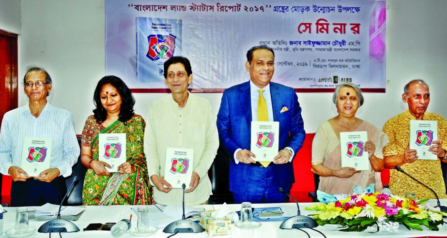 Land Minister Saifuzzaman Chowdhury along with others holds the copies of a book titled 'Bangladesh Land Status Report 2017' at its cover unwrapping ceremony organised by Association for Land Reform and Development in CIRDAP auditorium in the city on W