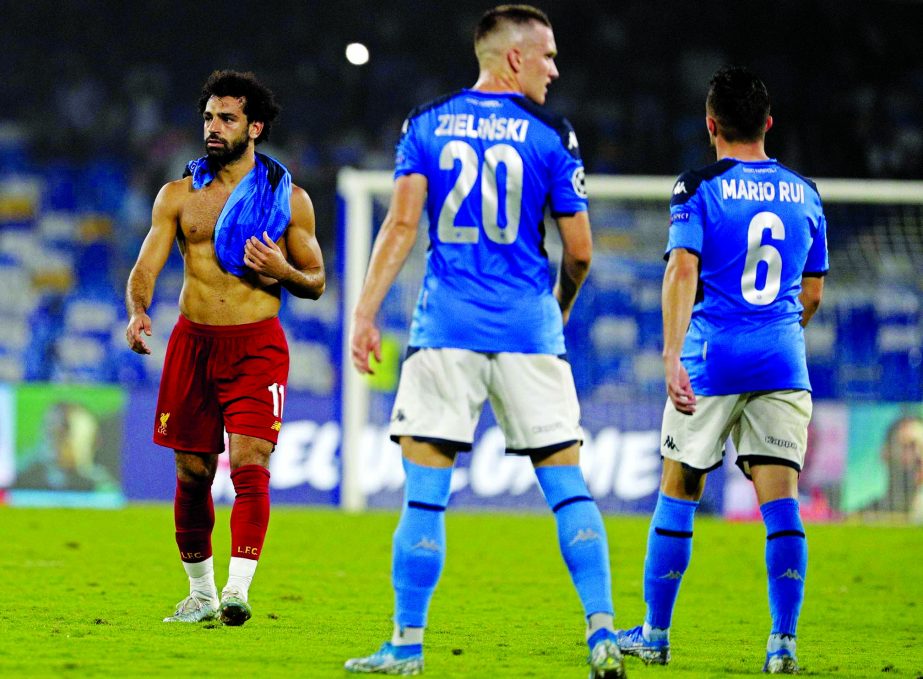 Liverpool's Mohamed Salah (left) leaves the pitch after the Champions League Group E soccer match between Napoli and Liverpool, at the San Paolo stadium in Naples, Italy on Tuesday.