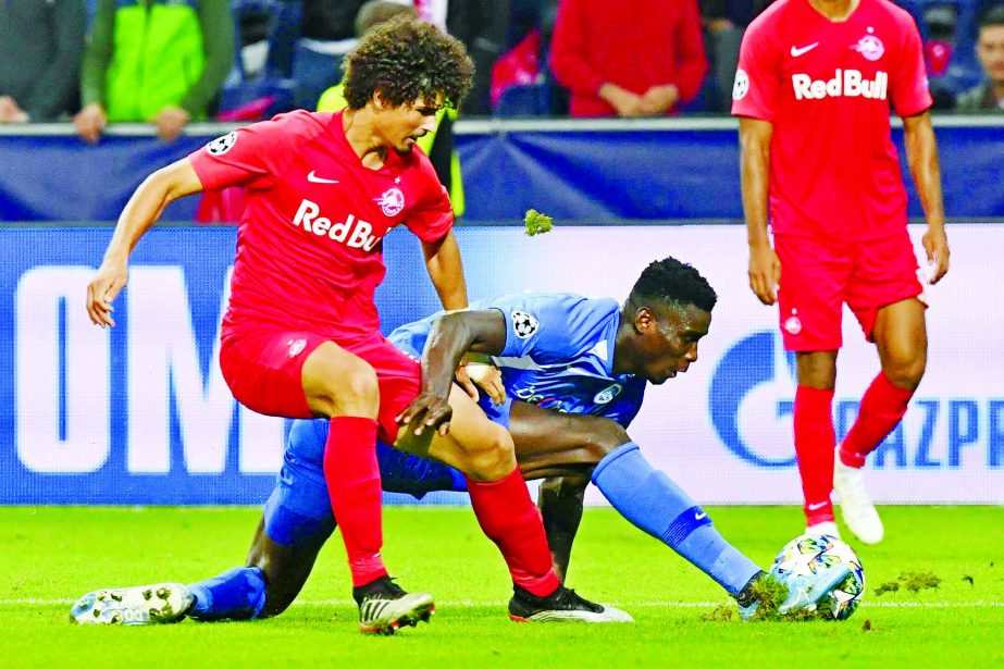 KRC Genk's Paul Onuachu (center) duels for the ball against FC Red Bull Salzburg player Andre Ramalho during the Champions League Group E match in Salzburg, Austria on Tuesday.