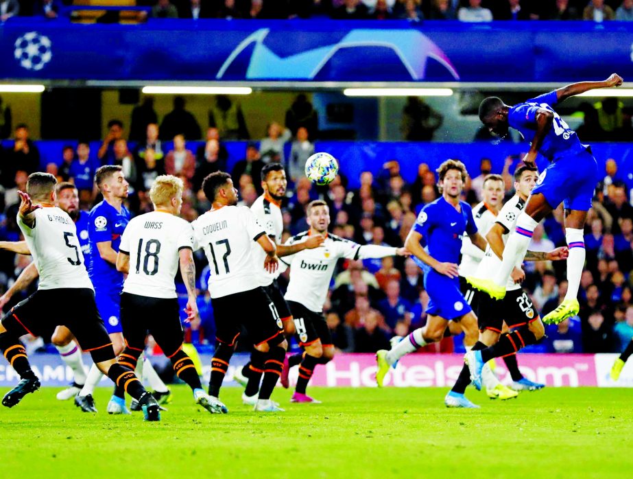 Chelsea's Fikayo Tomori (right) heads the ball during the Champions League Group H soccer match between Chelsea and Valencia at Stamford Bridge stadium in London on Tuesday.