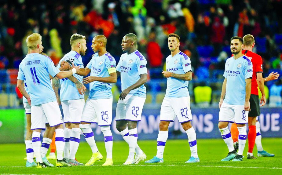 Manchester City players greet each other after the Group C Champions League soccer match between Manchester City and FC Shakhtar Donetsk in Kharkiv, Ukraine on Wednesday. Man City won the match 3-0.