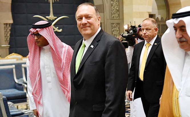 US Secretary of State Mike Pompeo speaks with a Saudi official before boarding his flight from Jeddah, Saudi Arabia to the UAE