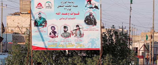 A billboard depicting Shiite spiritual leaders and volunteer fighters from the Iran-backed Popular Mobilization Forces who were killed in Iraq fighting Islamic State militants, is displayed in Basra, Iraq.
