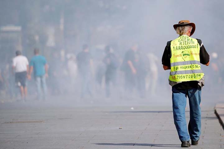 A protester wearing a yellow vest during a demonstration in France. The yellow vest movement erupted 10 months ago.