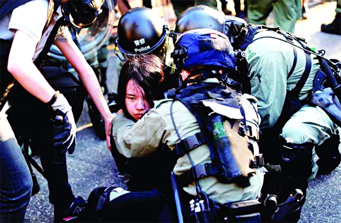 An anti-government protester is detained during a march in Tuen Mun, Hong Kong, China on Saturday.
