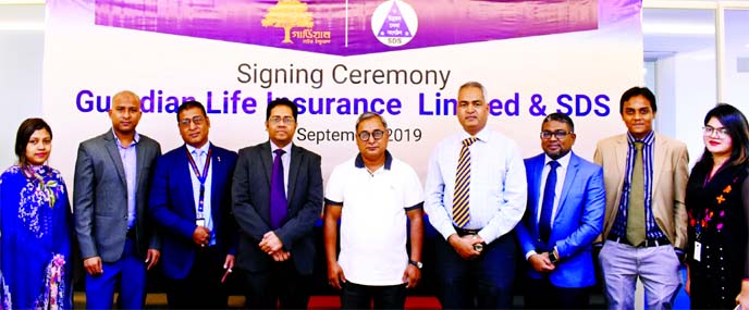 Mohammad Shazzadul Karim, DMD of Guardian Life Insurance Limited (GLIL) and Mozibur Rahman, Executive Director of Shariatpur Development Society (SDS), poses for photograph after signing an agreement to ensure the insurance coverage for the savers group a