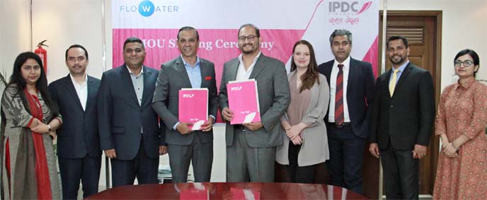 Mominul Islam, CEO of IPDC Finance Limited and Mustafa Azim Kasem Khan, Managing Director of FloWater Solutions Limited, poses for photo session after signing an agreement at IPDC head office in the city recently. Under the deal, IPDC will offer financing