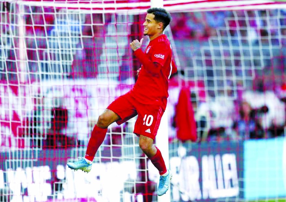 Bayern's Philippe Coutinho celebrates after scoring his side's 3rd goal by penalty during the German Bundesliga soccer match between FC Bayern Munich and 1. FC Cologne in Munich, Germany on Saturday.