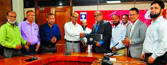 Armaan Siddiqui, Executive Vice-President of Robi and Md. Asafuddowla, Secretary of Bangladesh Rural Electrification Board (BREB), exchanging an agreement signing document at BREB head office in the city recently. Under the deal, BREB customers to pay the