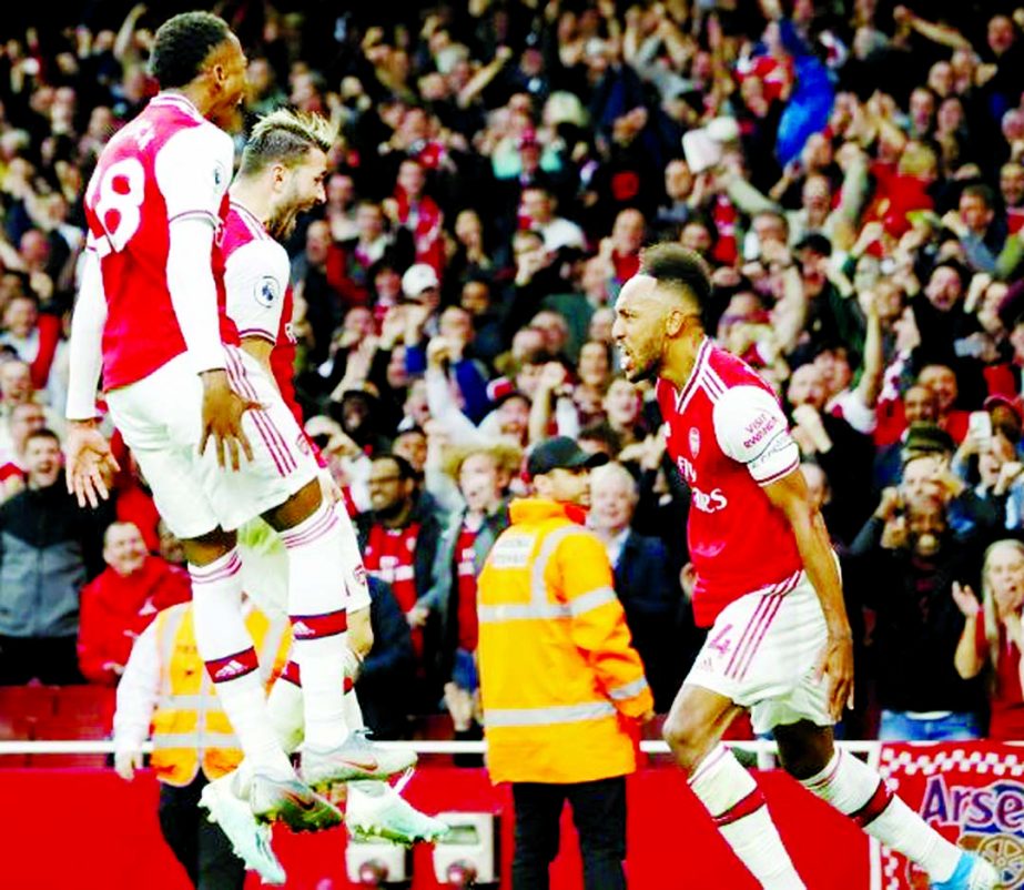 Pierre-Emerick Aubameyang (right) celebrates scoring the winner in a thrilling 3-2 victory over Aston Villa on Sunday.