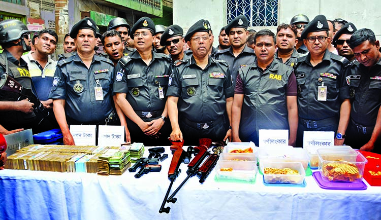 Rapid Action Battalion (RAB) recovered about Tk five crore in cash, 720 tolas of gold and firearms in raids in Dhaka's Gandaria area on Tuesday.