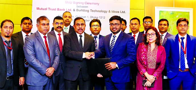 Md. Mahmudul Kabir, Executive Director of Building Technology & Ideas Limited (BTI) and Syed Rafiqul Haq, DMD of Mutual Trust Bank Limited (MTB), exchanging an agreement signing document at the bank's corporate head office in the city recently. Under the