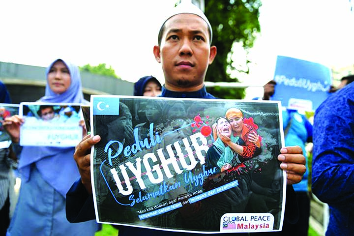 Photo shows people taking part in an event in front of the Chinese embassy in Kuala Lumpur in solidarity with the Uighur community in China.