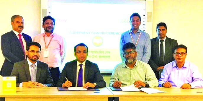 Gazi Yar Mohammad, Head of Agent Banking of ONE Bank Limited and Md. Ziaur Rahman, Managing Director of Bay Emporium Limited, signing an agreement at Bay's head office in the city on Monday. Under the deal, OK Wallet customers of the bank will be able to