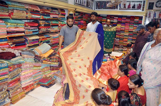 Shopping malls at the Port City are crowded with buyers ahead of Durga Puja. This picture was taken from a Showroom in Teribazar yesterday.