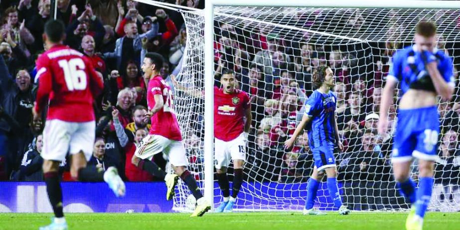 Manchester United's Mason Greenwood (center left) celebrates scoring his side's first goal of the game during their English League Cup, Third Round soccer match against Rochdale at Old Trafford on Wednesday.