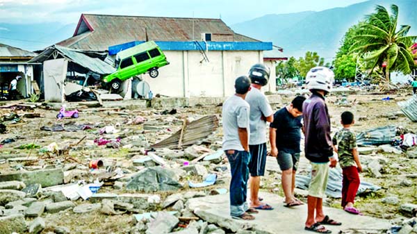 Thursday in a strong earthquake that rocked Indonesia's remote Maluku islands, triggering landslides that buried at least one of the victims, the disaster agency said.