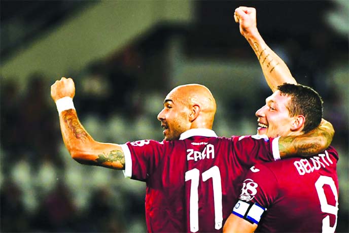 Torino's Italian forward Andrea Belotti (R) celebrates with his teammate after scoring a goal against AC Milan in their Italian Serie Soccer match at the Olympic Stadium in Rome on Thursday.