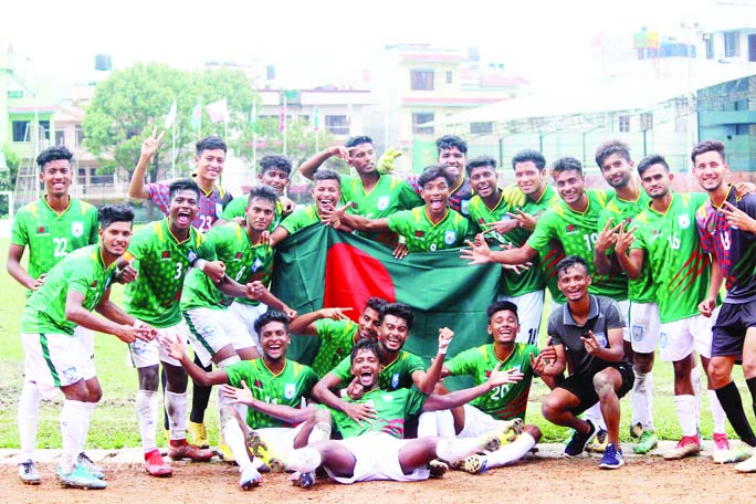 Players of Bangladesh Under-18 Football team celebrating with national flag after beating Bhutan Under-18 Football team in the semi-final match of the SAFF Under-18 Championship at APF Stadium in Kathmandu, Nepal on Friday.
