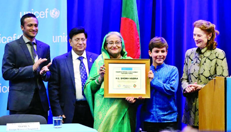 Prime Minister Sheikh Hasina received the prestigious 'Champion of Skills Dev for Youths Award' being handed over by Unicef Executive Director Henrietta Fore (right) at a ceremony held in New York on Thursday.