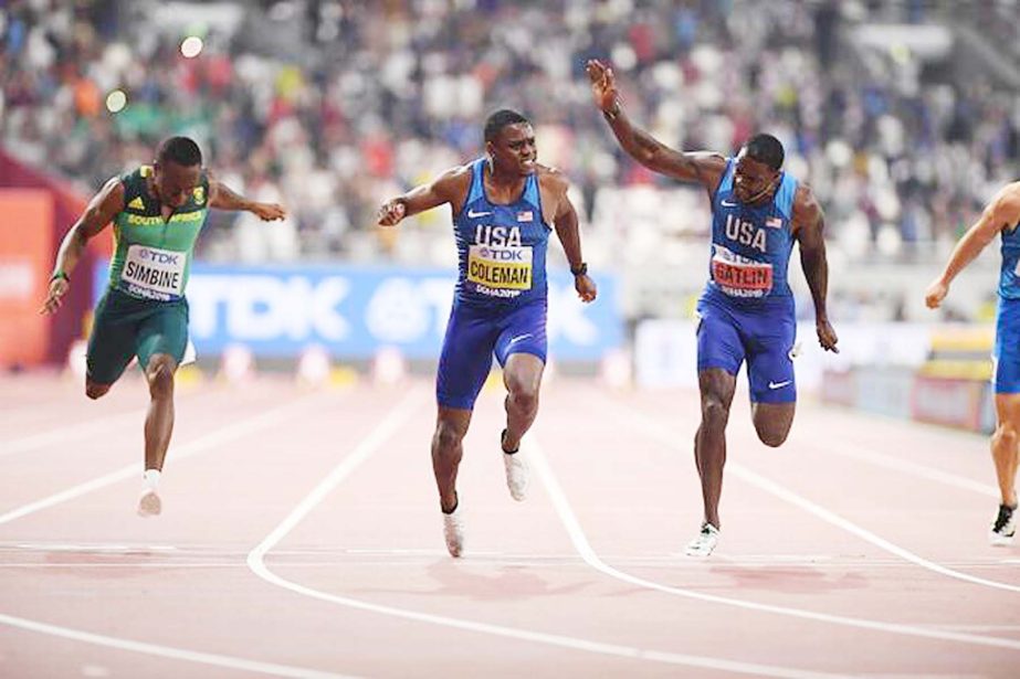 Christian Coleman (center) of the United States, crosses the finish line to win the Men's 100 Metres final final during day two of 17th IAAF World Athletics Championships Doha 2019 at the Khalifa International Stadium on Saturday.