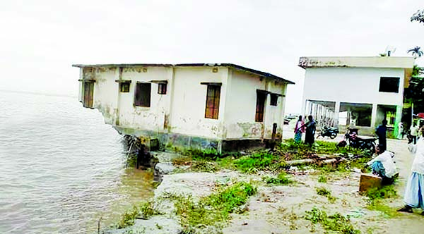 A community clinic built at Komalnagar upazila in Laxmipur and other establishments being devoured by the river erosion as upstream water rises further. This photo was taken on Sunday.