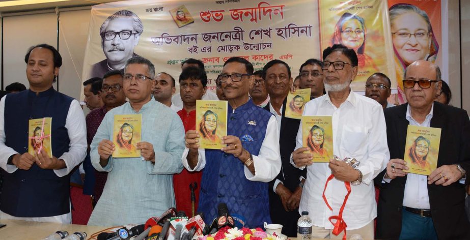 Road Transport and Bridges Minister Obaidul Quader along with others holds the copies of a book titled 'Shuva Janmadin Avhibadan Jananetri Sheikh Hisana' edited by General Secretary of the Sub-Committee of Information and Research of Awami League Advoca