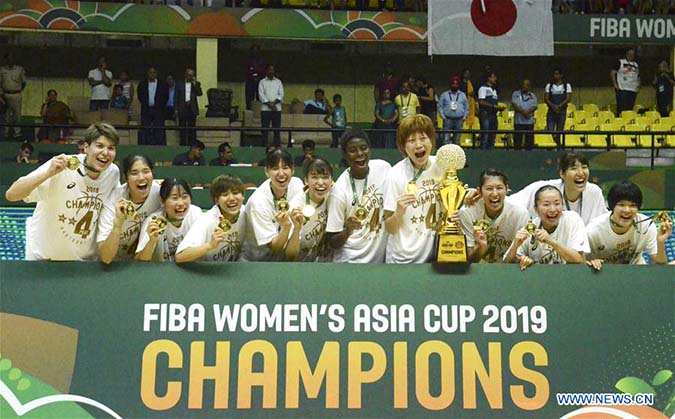 Players of Japan celebrate after the final match between China and Japan of the FIBA Women's Asia Cup in Bangalore, India on Sunday.