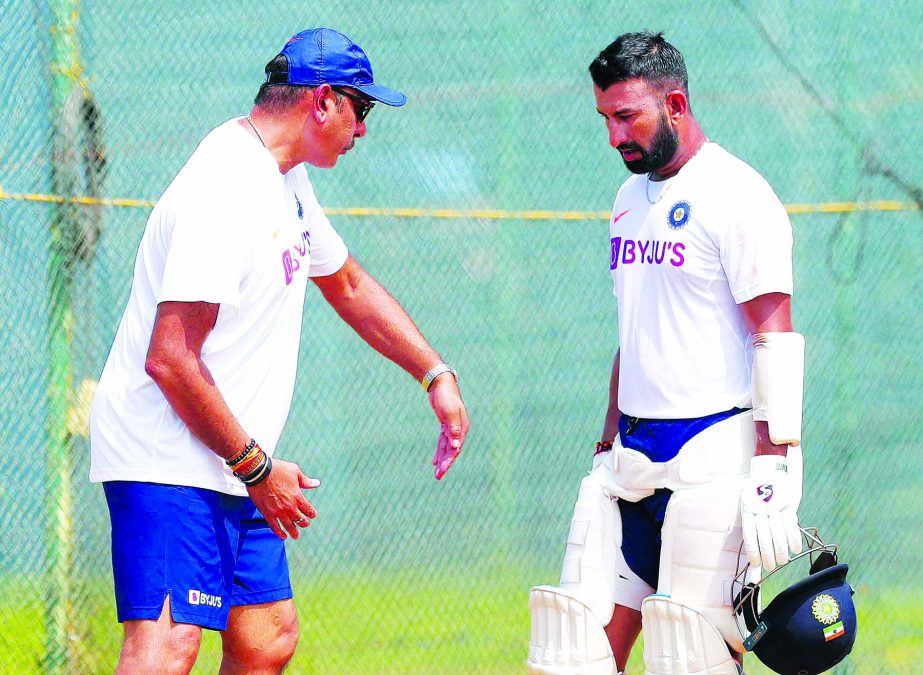 Indian cricket player Cheteshwar Pujara (right) listens to head coach Ravi Shastri after batting in the nets during a training session in Visakhapatnam, India on Tuesday. India and South Africa are scheduled to play the first Test cricket match of the thr