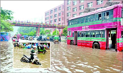 Most of the city roads, lanes and low-lying areas turn into virtual water pools following heavy rains for about two hours on Tuesday. This photo shows that rickshaws, cars and buses wade through knee-deep water in Motijheel after the downpour.