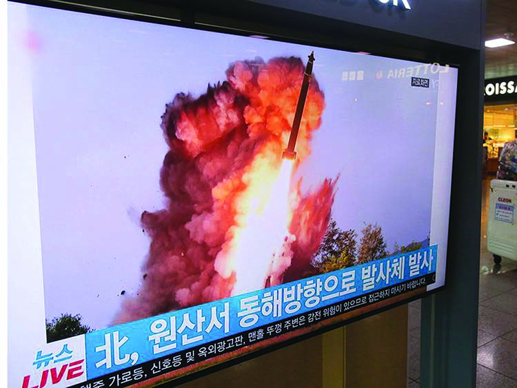 A TV screen shows a file image of a North Korea's missile launch during a news program at the Seoul Railway Station in Seoul, South Korea on Wednesday.