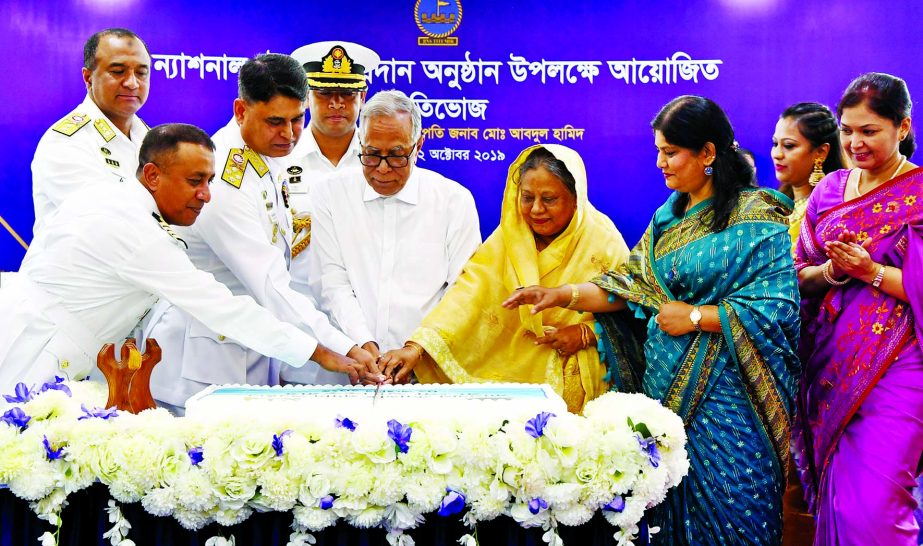 President Abdul Hamid cutting cake on the occasion of Awarding National Standard (National Flag) to BNS Titumir at the parade ground of the Titumir Naval Base Jetty in Khulna on Wednesday. PID photo