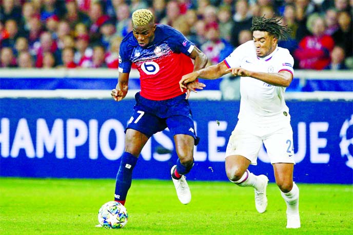Lille's Victor Osimhen ( left) fights for the ball with Chelsea's Reece James during the group H Champions League soccer match between Lille and Chelsea at the Stade Pierre Mauroy - Villeneuve d'Ascq stadium in Lille, France on Wednesday.