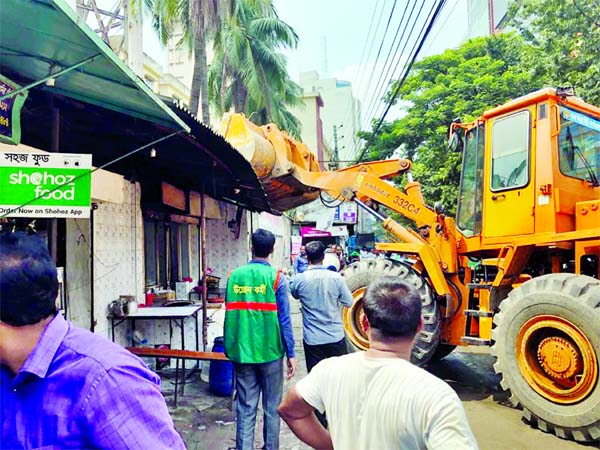Unauthorized establishments set up at Mohakhali being bulldozed on Thursday as the Dhaka North City Corporation (DNCC) conducts eviction drive to free footpaths from illegal occupation.