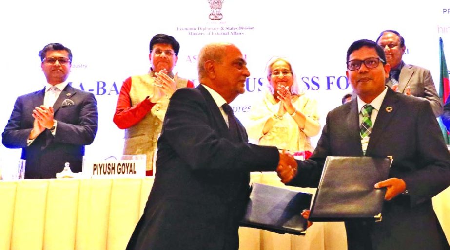 In presence of Prime Minister Sheikh Hasina, Zunaid Ahmed Palak, State Minister for ICT, exchanging a MoU signing document with an Indian business leader at ICT Maiyura Hotel in New Delhi on Friday.