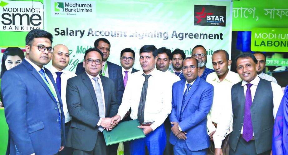 Md. Shaheen Howlader, Head of SME & Retail Banking Division of Modhumoti Bank Limited and Md. Zahidul Haque, Managing Director of Star Electronics Limited, exchanging an agreement signing document at the bank's head office in the city recently. Under the