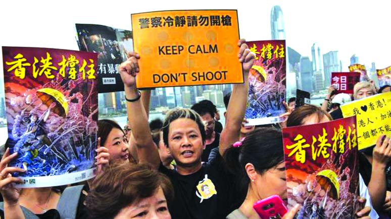 Protestors hold up placards during an anti-government rally.