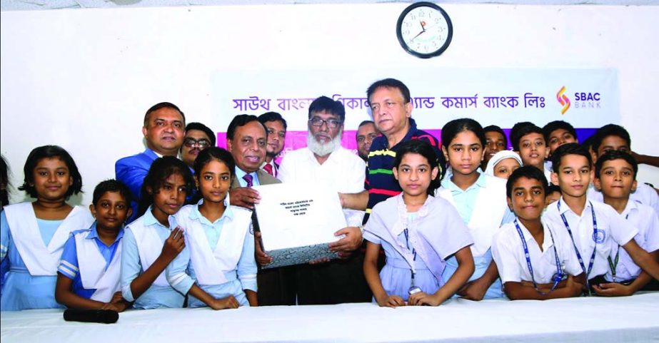 Md. Golam Faruque, CEO of South Bangla Agriculture and Commerce (SBAC) Bank Limited, distributing educational materials to the Lake Circus Girl's School in the city on Thursday. Senior officials of the bank were also present.