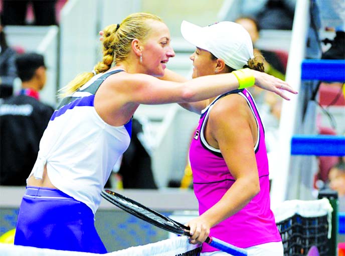 Australia's Ashleigh Barty (right) embraces Petra Kvitova of the Czech Republic, after winning the quarter-final of the China Open tennis in Beijing on Friday.